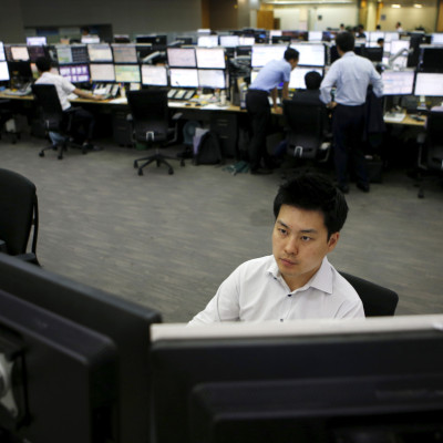 A currency dealer works at a dealing room of a bank in Seoul