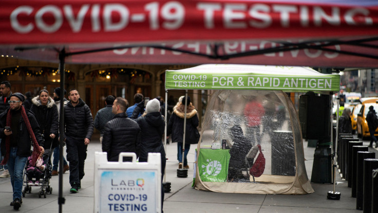 People walk next to COVID-19 testing sites in New York