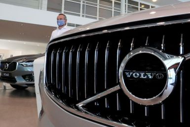 An employee at a Volvo car dealer, wearing a protective mask is seen in a showroom, in Brussels, Belgium