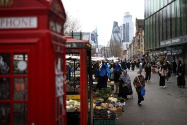 People browse stalls at a street market in east London