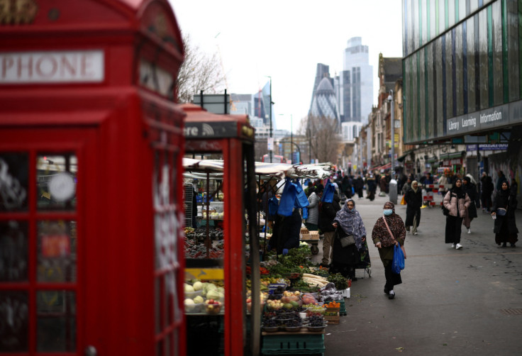 People browse stalls at a street market in east London