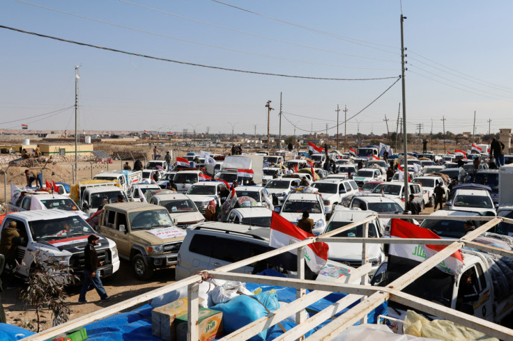 Vehicles containing aid from Hashid Shaabi, are parked on the Iraqi side of Iraq-Syria border