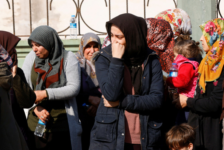 Women grieve for the loss of family members, following the deadly earthquake, in Reyhanli