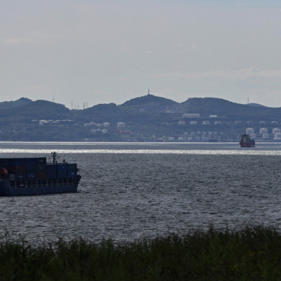 A container ship sails along Nakhodka Bay near the oil terminal in the port city of Nakhodka
