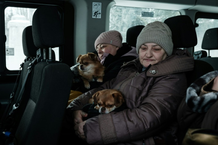 Lubov (R) and her daughter Olena are heading to the western city of Lviv with their two dogs