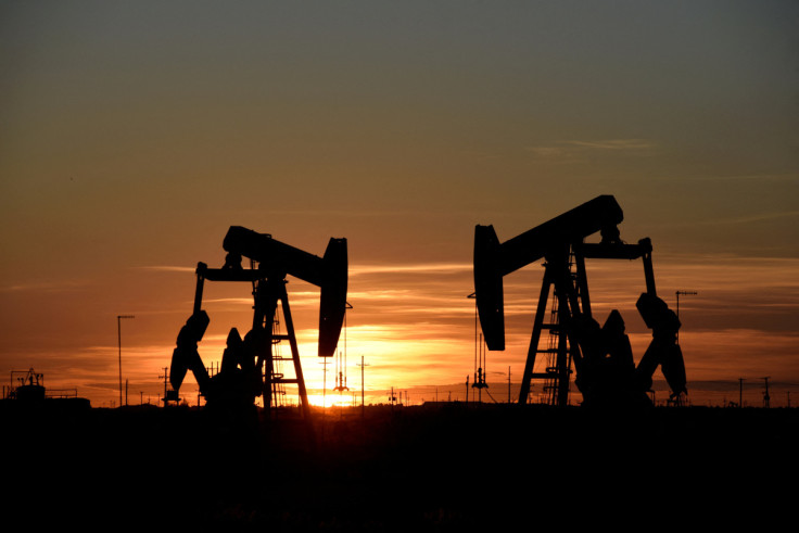 Pump jacks operate at sunset in an oil field in Midland