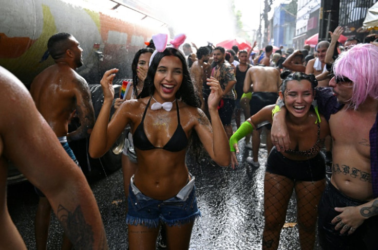 Water cannon soak revelers during a street party in Rio