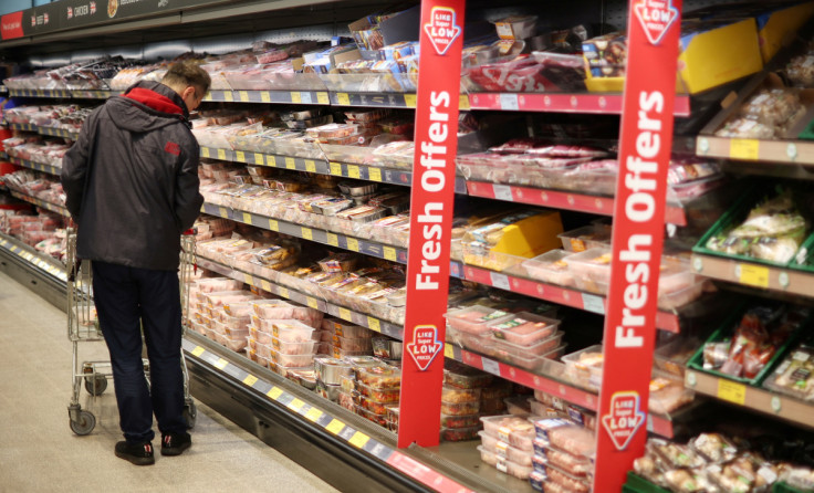 Shopper walks along the meat aisle inside an ALDI supermarket near Altrincham