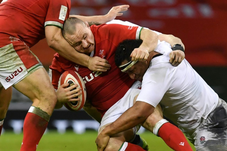 Fronting up: Ken Owens carries the ball into England's Mako Vunipola as Wales won the last Six Nations meeting in Cardiff between the teams, on the way to winning the title in 2021