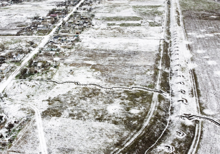 Trenches line the ground, which were used during the months of Russian occupation, amid Russia's invasion of Ukraine, in the village of Posad-Pokrovske