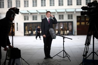 British Chancellor of the Exchequer Jeremy Hunt talks to a television crew outside the BBC headquarters in London