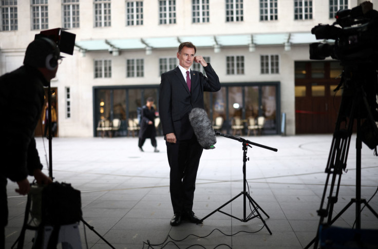 British Chancellor of the Exchequer Jeremy Hunt talks to a television crew outside the BBC headquarters in London