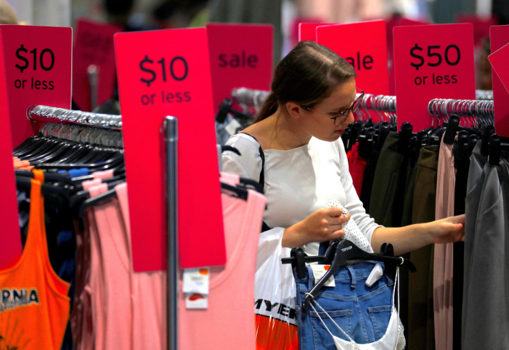 FILE PHOTO - A shopper holds items and looks at others on sale at a clothing retail store in central Sydney, Australia