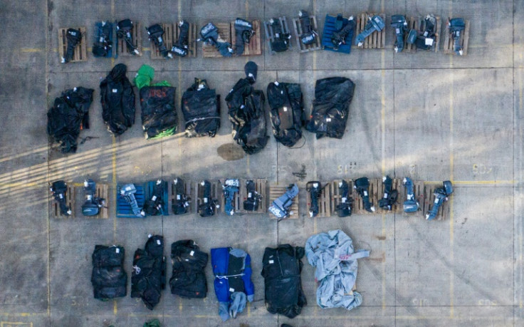 An aerial view shows rolled- up inflatable dinghies and outboard engines, stored in a Port Authority yard in Dover, southeast England on March 6, 2023, that are believed to have been used by migrants who were picked up at sea whilst crossing the Channel t