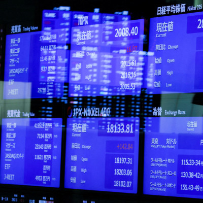 Monitors displaying the stock index prices and Japanese yen exchange rate against the U.S. dollar are seen at the Tokyo Stock Exchange in Tokyo