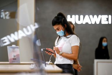 An employee uses a Huawei P40 smartphone at the IFA consumer technology fair, in Berlin