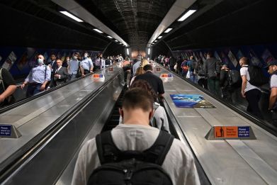 Workers travel through London Bridge rail and underground station during the morning rush hour in London
