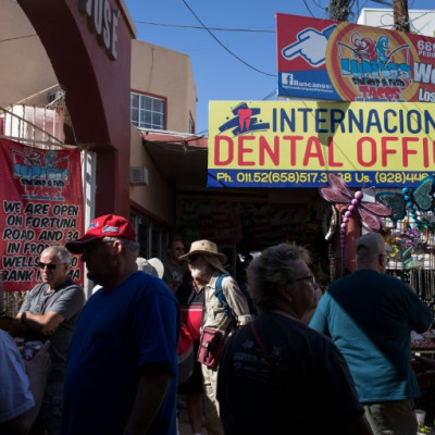 Visitors from the United States walk past a dental office in downtown Los Algodones, near the US-Mexico border in 2017