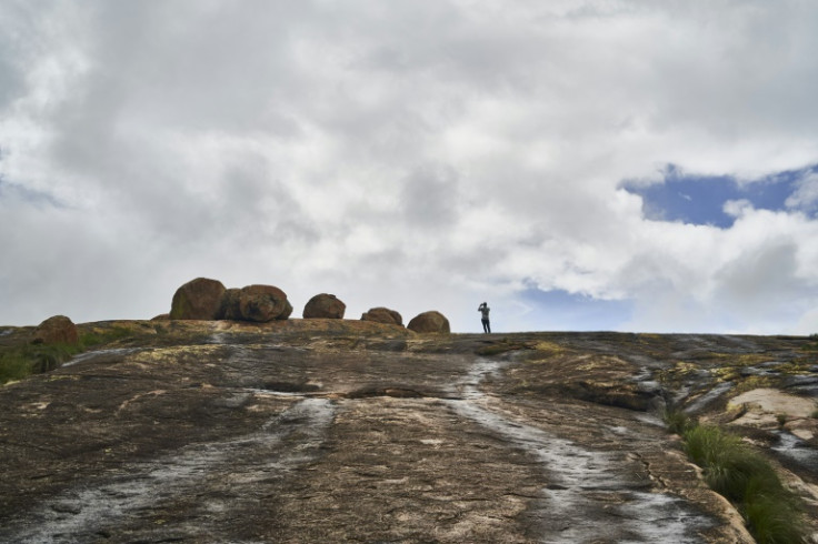 Located on the hilltop, the grave is surrounded by imposing rocks