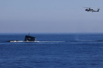 A S70C helicopter can be seen flying around SS793 Submarine as part of Taiwan's main annual "Han Kuang" exercises