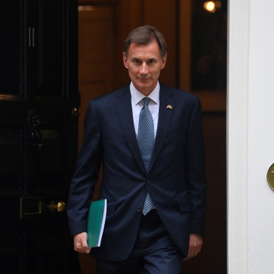 Britain's Chancellor of the Exchequer Jeremy Hunt walks at Downing Street in London
