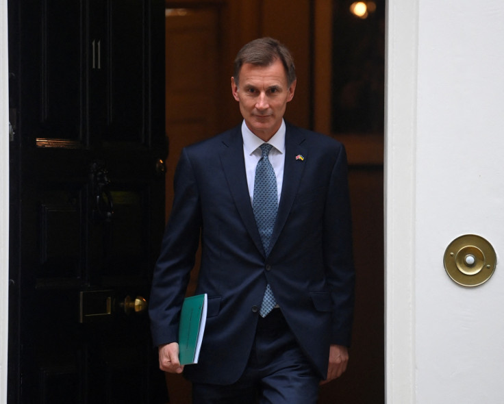 Britain's Chancellor of the Exchequer Jeremy Hunt walks at Downing Street in London