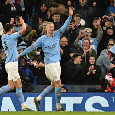 High five: Erling Haaland (right) scored five goals in Manchester City's Champions League demolition of RB Leipzig