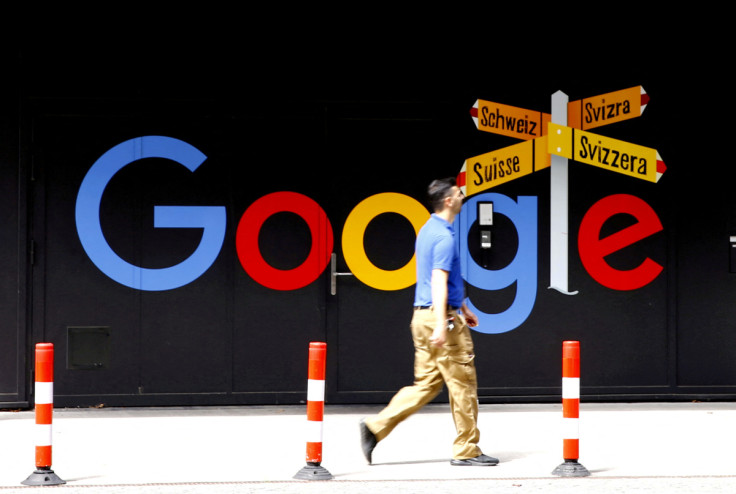 A man walks past a logo of Alphabet Inc's Google in Zurich