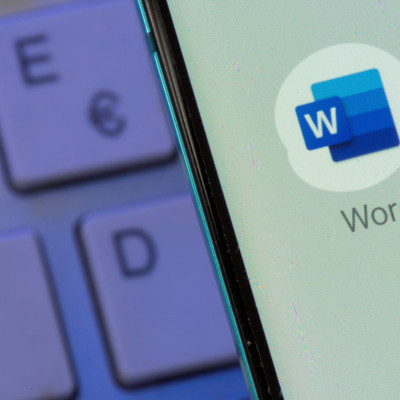 Microsoft Word app is seen on the smartphone placed on the keyboard in this illustration taken