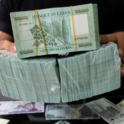A money exchange vendor displays Lebanese pound banknotes at his shop in Beirut