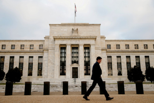 A man walks past the Federal Reserve Bank in Washington DC