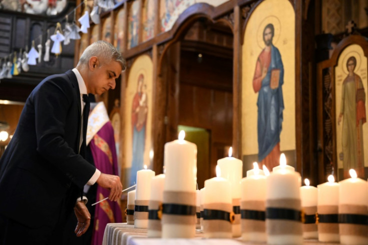 Mayor of London Sadiq Khan lights a candle symbolising 52 weeks of the Ukraine conflict