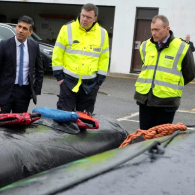 Britain's Prime Minister Rishi Sunak looks at buoyancy aids and an inflatable rubber dinghy during a visit to the port of Dover