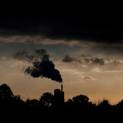 Smoke rises above a factory at sunset in Rugby, Britain