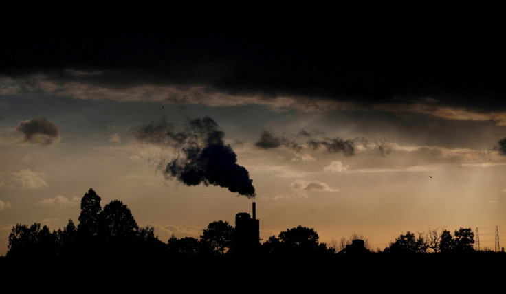 Smoke rises above a factory at sunset in Rugby, Britain