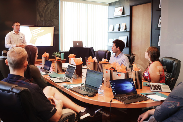 A man presenting to his office teammates 