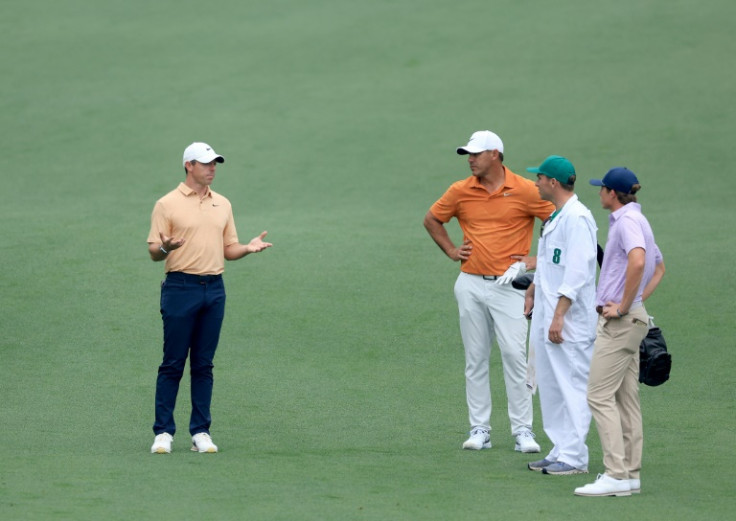 Rory McIlroy talks with Brooks Koepka, who plays in the upstart LIV Golf League, during practice on Tuesday for this week's Masters tournament at Augusta National