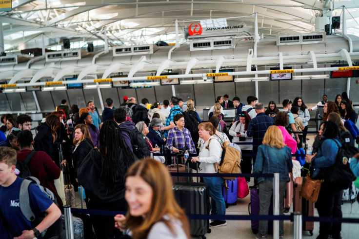 Travelers wait to check in at  John F. Kennedy International Airport in New York