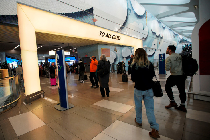 Travelers walk toward gates at LaGuardia airport in New York