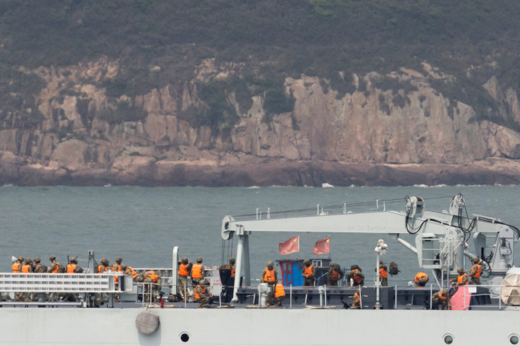 Soldiers stand on the deck of a Chinese warship as it sails during a military drill near Fuzhou, Fujian Province, near the Taiwan-controlled Matsu Islands