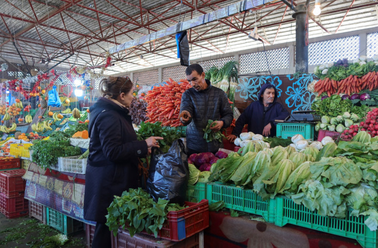 A woman shops at a vegetable and fruit market in Tunis