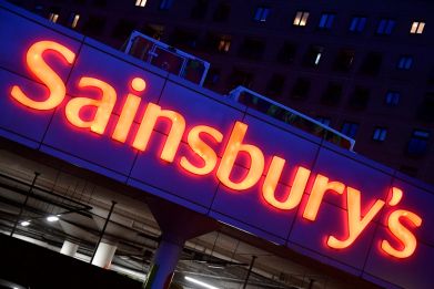 Illuminated signage is seen at a branch of the Sainsbury's supermarket in London