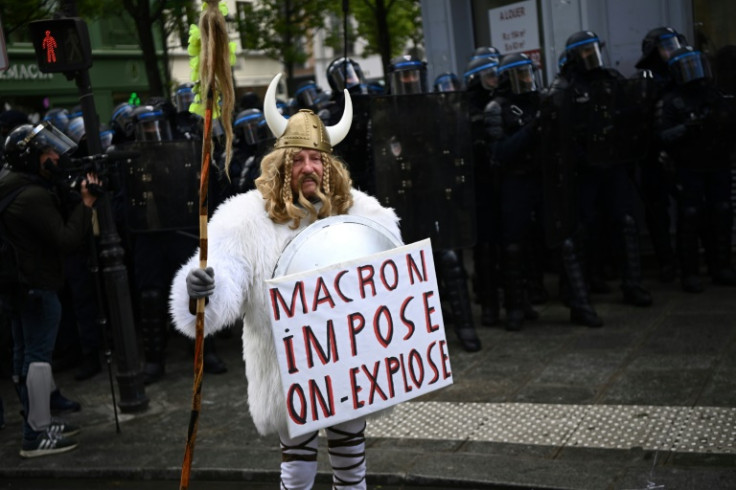 'Macron imposes, we explode,' read one protester's sign in Paris on Thursday
