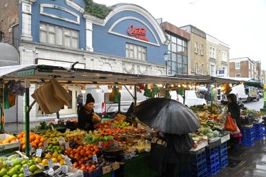 Customers shop at a fruit and vegetable stall at Portobello Road in London