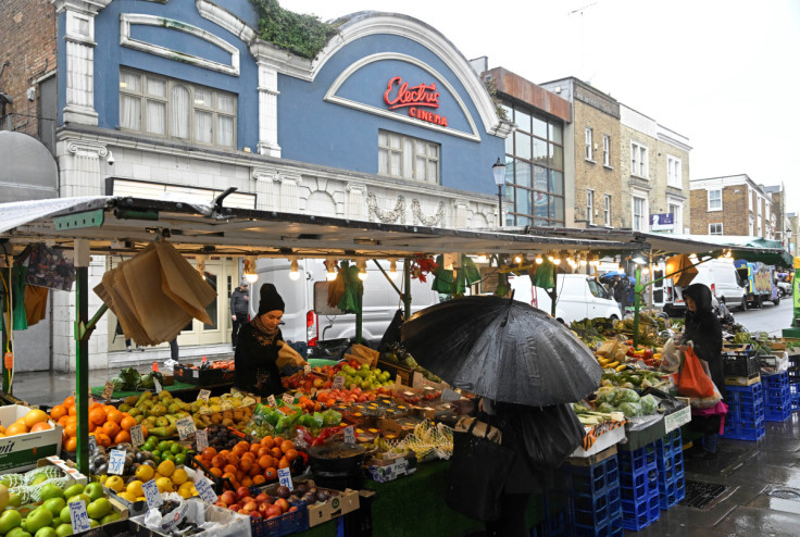 Customers shop at a fruit and vegetable stall at Portobello Road in London