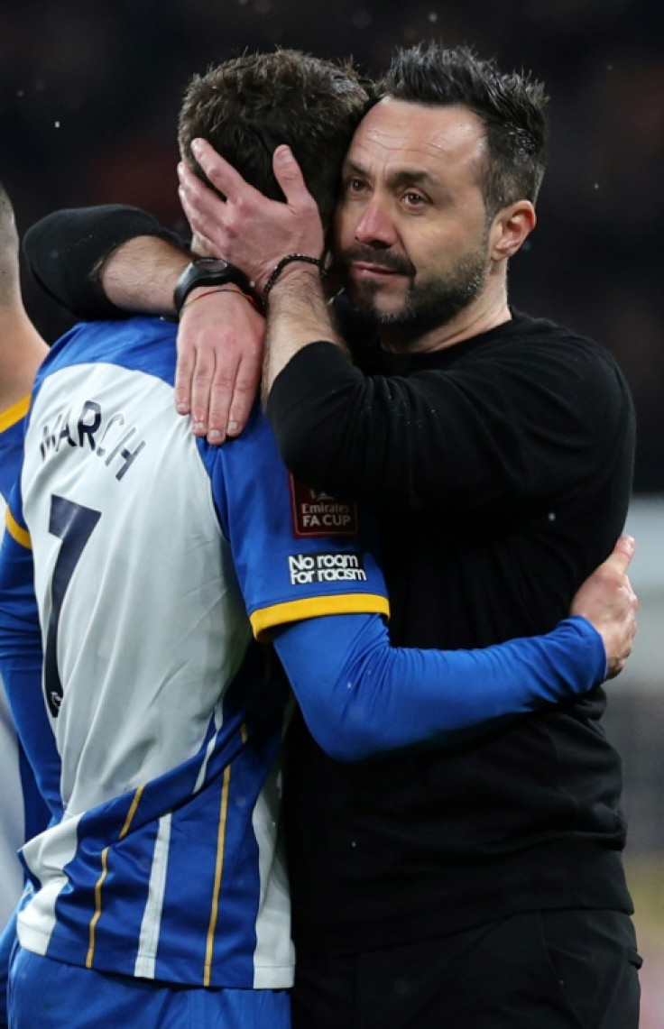 Hard to take: Brighton coach Roberto De Zerbi consoles Solly March after he missed his penalty