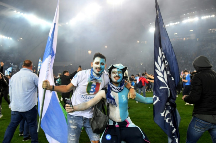 Friendly invasion: Napoli fans on the pitch to celebrate the Italian Serie A title