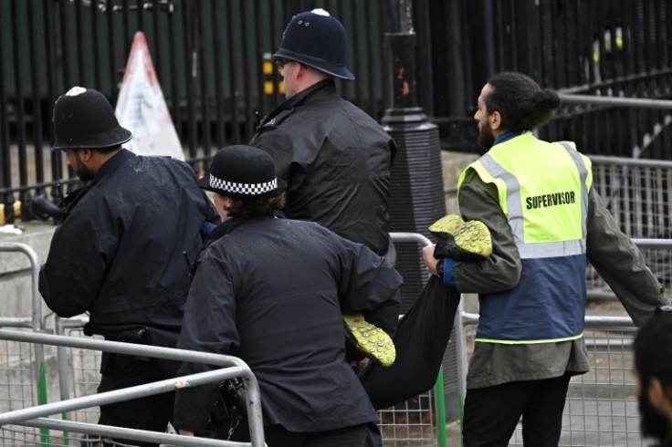 Police officers arrest a protester from the 'Just Stop Oil' group, close to where Britain's King Charles III will be crowned at London's Westminster Abbey