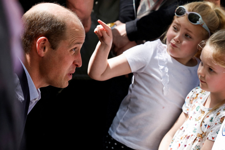 Britain's Prince William and Catherine, Princess of Wales greet well-wishers along the Long Walk outside Windsor Castle