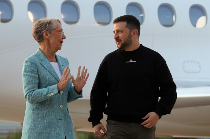 Ukraine's President Volodymyr Zelensky is welcomed by French Prime minister Elisabeth Borne upon his arrival at Villacoublay Air Base, southwest of Paris on Sunday